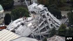 FILE - Rescue workers climb onto the collapsed Pyne Gould Guinness Building in central Christchurch, New Zealand, Feb. 22, 2011.