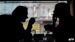 Guests of a Vienna's Cafe/Bar smoke cigarettes with their drinks in Vienna, Austria, on March 22, 2018. Austrian MPs scrapped a smoking ban in bars and restaurants that was due to come into force in May.