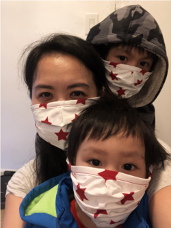 Nisakorn Quispe with her 2 and 6 years old son, Napat and Navin, wearing a protective face mask on April 18, 2020, at their home in Queens, New York City