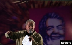 Former Brazilian President Luiz Inacio Lula da Silva gestures as he attends a meeting with women activists in Santo Andre, Brazil, Aug. 15, 2016.