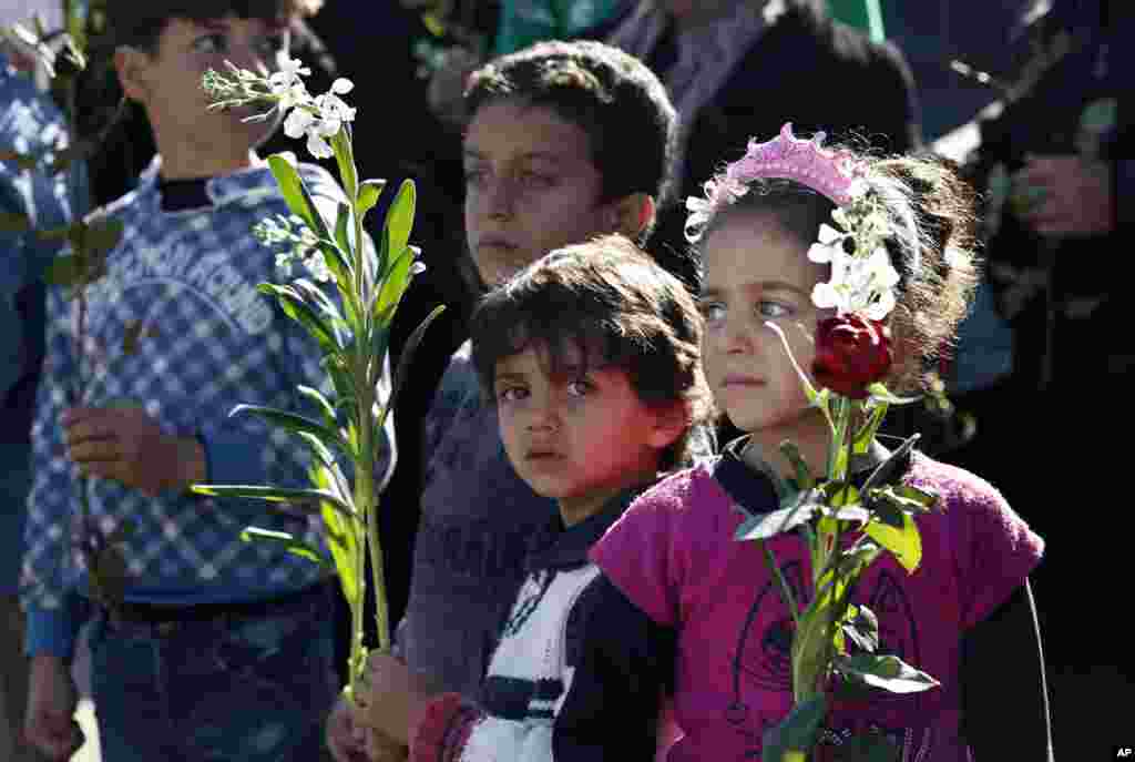 Families of wounded Syrian opposition fighters wait for their release at the Lebanese border crossing point of Masnaa. Syrian opposition fighters, some on wheelchairs, stretchers or crutches left the Syrian mountain resort of Zabadani toward the Lebanon border, where they will be flown to Turkey.