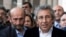 FILE - Can Dundar, right, editor-in-chief of Turkish opposition newspaper Cumhuriyet, and Erdem Gul, the paper's Ankara representative, speak to media outside an Istanbul courthouse, Nov. 26, 2015.