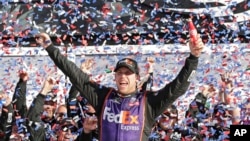 Denny Hamlin celebrates in Victory Lane after winning the NASCAR Daytona 500 Sprint Cup Series auto race at Daytona International Speedway in Daytona Beach, Florida, Sunday, Feb. 21, 2016.