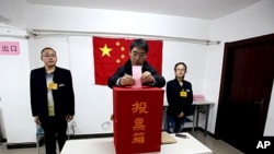 A Chinese man casts his vote during the local people's congress election in Beijing. Most candidates are chosen by the government or Communist Party officials and while independents can take part if they have the backing of 10 people or more, few have wo