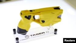 FILE - An X2 Taser gun is shown on display at the Taser booth during the International Association of Chiefs of Police conference in San Diego, California, Oct. 17, 2016. 