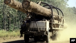 A truck carries logs on a rural road is seen in this July, 2002 photo taken in Preah Vihear province some 245 kilometers (152 miles) north of Phnom Penh, file photo. 