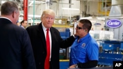 President-elect Donald Trump talks with workers during a visit to the Carrier factory, Dec. 1, 2016, in Indianapolis, Indiana. Trump is warning American businesses they will face a stiff tax if they manufacture their products abroad and then sell them in the U.S.