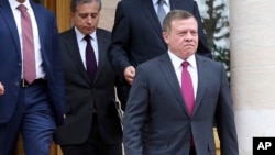 FILE - Jordanian King Abdullah II, right, leaves following a meeting at the Jordanian Royal Palace in Amman, Jan. 15, 2017. 