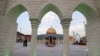 Visitors and staff walk near a scale model of Jerusalem's Al-Aqsa mosque at the Land of Civilizations art and culture show in Tehran, on August 11, 2024.