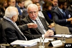 FILE - Minister of Foreign Affairs of the Palestinian Authority Riyad al-Maliki (R) listens to a colleague during a hearing at the ICJ on the legal consequences of the Israeli occupation of Palestinian territories, in The Hague on February 19, 2024.