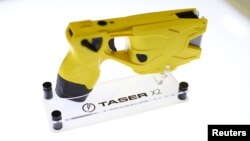 FILE - An X2 Taser gun is shown on display at the Taser booth during the International Association of Chiefs of Police conference in San Diego, California, Oct. 17, 2016. 