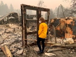 FILE - This photo provided by her office shows Oregon Gov. Kate Brown during a visit to the front line of the Beachie Creek Fire, in Beach Creek, Ore., Sept. 16, 2020.