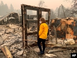 FILE - This photo provided by her office shows Oregon Gov. Kate Brown during a visit to the front line of the Beachie Creek Fire, in Beach Creek, Ore., Sept. 16, 2020.