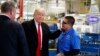 President-elect Donald Trump talks with workers during a visit to the Carrier factory, Dec. 1, 2016, in Indianapolis, Indiana. Trump is warning American businesses they will face a stiff tax if they manufacture their products abroad and then sell them in the U.S.