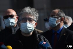 FILE - Turkish-French journalist Erol Onderoglu, Reporters Without Borders representative in Turkey, speaks to the press before his trial for "terrorist propaganda," in front of Istanbul's courthouse building, Feb. 3, 2021.