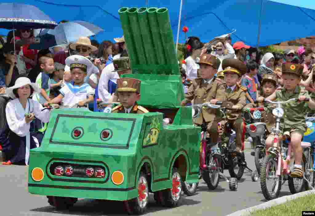 Children take part in a mock military parade at an amusement park in Pyongyang, North Korea, to mark International Children&#39;s Day, in this photo taken by Kyodo, June 1, 2013. 