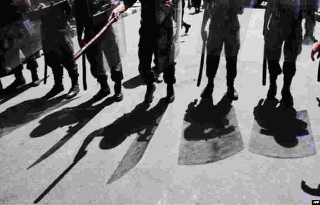 Yemeni riot police officers up against protestors in Yemen, as they demonstrate demanding the resignation of President Ali Abdullah Saleh. (AP/Muhammed Muheisen)