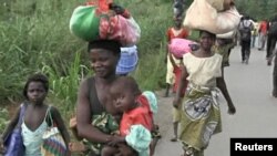 FILE - People leave Begoua for CAR's capital Bangui, March 23, 2013. 