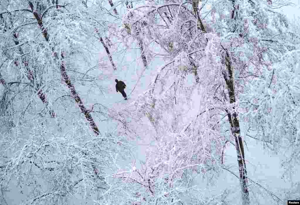 A man walks in a snow-covered park after snowfall in Kyiv, Ukraine.