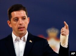 Serbian government official Marko Djuric gestures with an injured hand as he speaks during a press conference in Belgrade, Serbia, March 27, 2018.