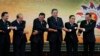 Brunei Sultan Hassanal Bolkiah, left, and other leaders of the Association of Southeast Asian Nations join their hands for a group photo section during the 22nd ASEAN Summit in Bandar Seri Begawan, Brunei, Thursday, April 25, 2013. They are, from left, Bo