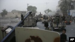 In this Friday Aug. 9, 2019 frame grab from video, Southern Transitional Council separatist fighters line up to storm the presidential palace in the southern port city of Aden, Yemen. The separatists backed by the United Arab Emirates began withdrawing Su
