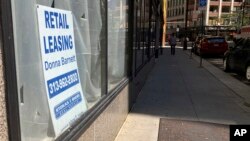 A sign in a window advertises retail leasing in Detroit, September 2, 2021. Downtown businesses that once took for granted an office-worker clientele have had to adapt as offices remain closed and workers stay home. (AP Photo/Mike Householder)
