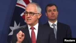 Australian Prime Minister Malcolm Turnbull speaks as Australia's Minister for Justice Michael Keenan listens on during a media conference in Sydney, Australia, July 30, 2017.