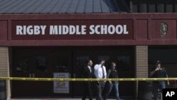 Officers leave Rigby Middle School after a shooting in Rigby, Idaho on Thursday, May 6, 2021. Authorities say a shooting at the eastern Idaho middle school has injured two students and a custodian, and a male student has been taken into custody. (John Roa