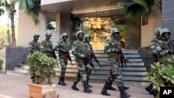 Soldiers from the presidential guard patrol outside the Radisson Blu hotel in Bamako, Mali, in anticipation of the president's visit, Nov. 21, 2015.
