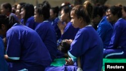 FILE PHOTO - A prisoner holds her daughter during a ceremony at Prey Sar prison in Phnom Penh, Cambodia, March 8, 2015. 