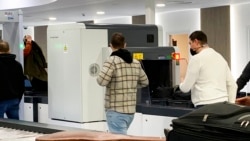 Passengers walk next to Nuctech security scanners at the Brussels Eurostar train terminal on Jan. 17, 2022.