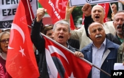 People stage a demonstration in front of the Turkish Parliament in support of a bill to strip immunity of parliamentarians in Ankara, May 4, 2016.