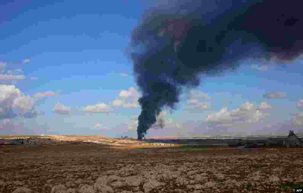 Smoke billows from a weapons depot allegedly belonging to rebel fighters during an operation by Syrian regime forces to take control of the Al-Maleh farms, west of the Handarat hill which is located just north of Aleppo.