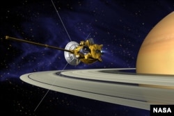 An artists concept of Cassini during the Saturn Orbit Insertion maneuver, just after the main engine has begun firing.