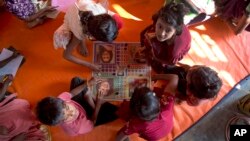 FILE - Rohingya refugee children play inside a makeshift school at Kutupalong Refugee Camp near Cox's Bazar, Bangladesh, Jan. 21, 2018.