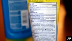 FILE - Sunscreen ingredients, including octinoxate, are shown May 2, 2018, in San Jose, Calif. 