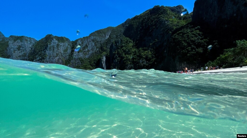 Tourists visit Maya Bay as Thailand reopens its world-famous beach after closing it for more than three years to allow its ecosystem to recover from the impact of overtourism, at Krabi province, Thailand, January 3, 2022. (REUTERS/Jorge Silva)