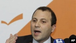 Lebanese Energy Minister Jibran Bassil announces the resignation of Hezbollah ministers and their allies during a press conference in the northern Beirut suburb of Rabieh, 12 Jan 2011