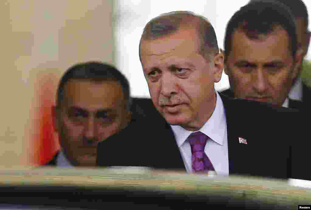 Turkish President Tayyip Erdogan (C) looks on after arriving at Esenboga Airport in Ankara, June 8, 2015.