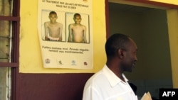 FILE - A wall displays a sign on how treatment with antiretroviral drugs can make you healthier at the Mfou district hospital, 30 kms from Yaounde, in Cameroon, Sept. 27, 2007.