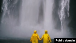 The two people are wearing raincoats over their clothes.