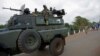 Uganda People's Defence Forces (UPDF) soldiers ride on their armored personnel carrier (APC) enroute to evacuate their citizens following recent fighting in Juba at Nimule town along the South Sudan and Uganda border, July 14, 2016.