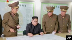 This image made from video of an Aug. 14, 2017, still image broadcast in a news bulletin, Aug. 15, 2017, by North Korea's KRT shows North Korean leader Kim Jong Un receiving a briefing in Pyongyang.