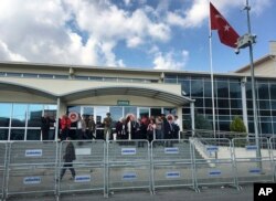 People gather outside a court in Silivri, Turkey, Oct. 11, 2017, where German journalist Mesale Tolu was standing trial.