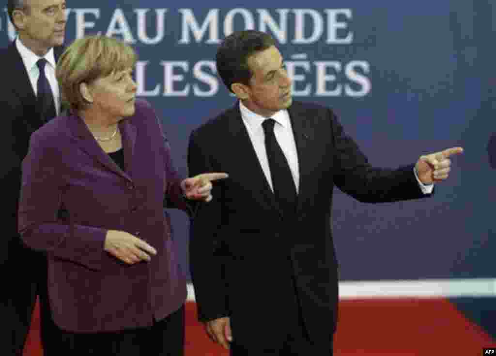 RETRANSMISSION TO IMPROVE TONING - French President Nicolas Sarkozy, right, speaks with German Chancellor Angela Merkel as they arrive for the G20 summit in Cannes, France on Wednesday, Nov. 2, 2011. Greek Prime Minister George Papandreou was flying to th