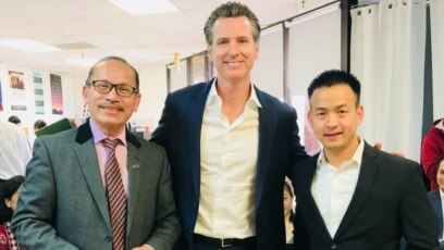 Mai Quyền (phải) được Thống đốc bang California Gavin Newsom (giữa) ân xá cho bản án năm 2005 và đang giúp đỡ những người Việt khác đối mặt trục xuất có cơ hội ân xá như anh. (Photo courtesy of Mai Quyen)