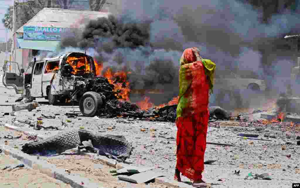 A Somali woman reacts near the site of a car bomb in central Mogadishu, March 18, 2013. At least eight people were killed in one of the bloodiest attacks in the war-ravaged capital in recent months, police said.