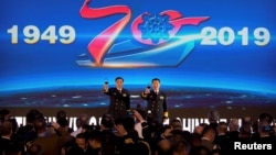 Vice Admiral Shen Jinlong, commander of the Chinese People's Liberation Army (PLA) Navy, and Vice Admiral Qin Shengxiang, political commissar of the PLA Navy, give a toast at a welcome reception for the commemoration of the 70th anniversary of the foundin