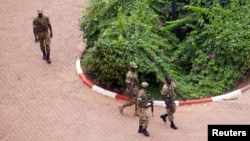 FILE - Presidential guard soldiers are seen on the grounds of the Laico Hotel in Ouagadougou, Burkina Faso, Sept. 20, 2015.